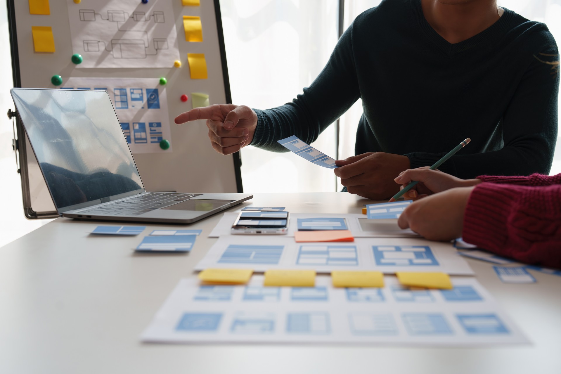 Group of ux developer and ui designer brainstorming about app interface design at modern office. Creative digital development agency.